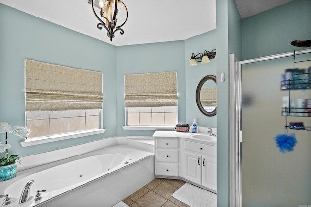 bathroom with vanity, a tub with jets, a stall shower, tile patterned flooring, and a chandelier