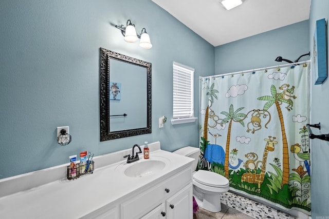 full bathroom with tile patterned flooring, curtained shower, toilet, and vanity