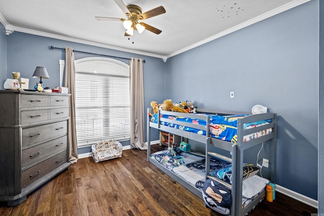 bedroom featuring ceiling fan, crown molding, baseboards, and wood finished floors