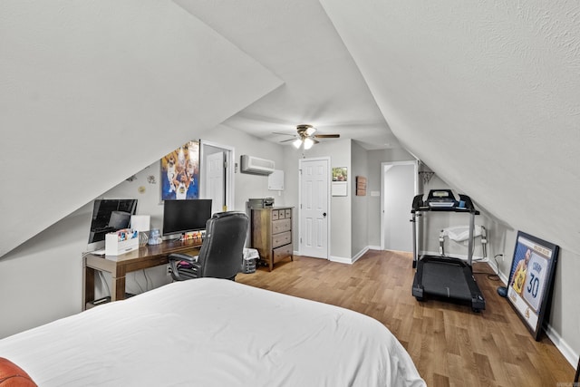 bedroom with a ceiling fan, vaulted ceiling, wood finished floors, and baseboards