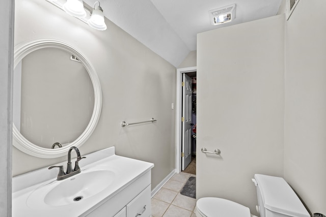 bathroom featuring vanity, visible vents, tile patterned flooring, vaulted ceiling, and toilet