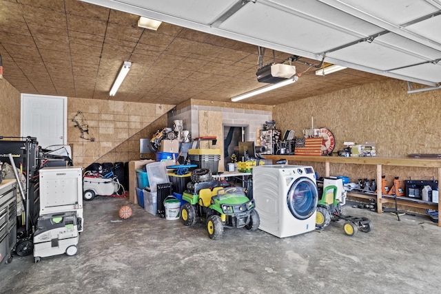 garage with a workshop area and a garage door opener