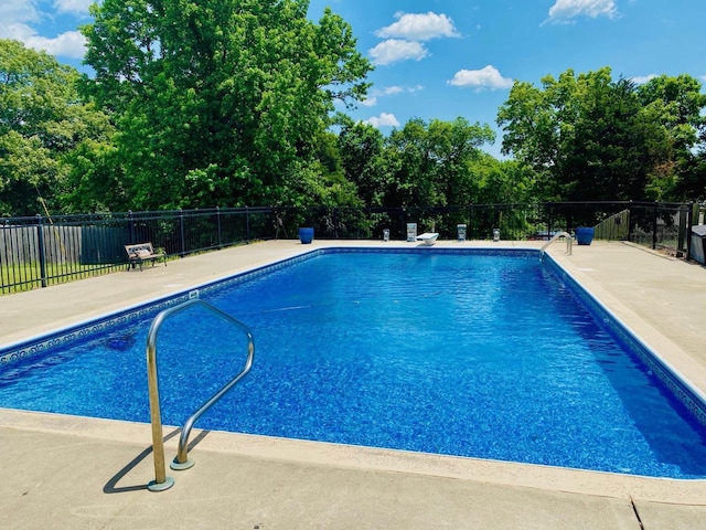 view of pool with a patio area, a fenced in pool, and fence