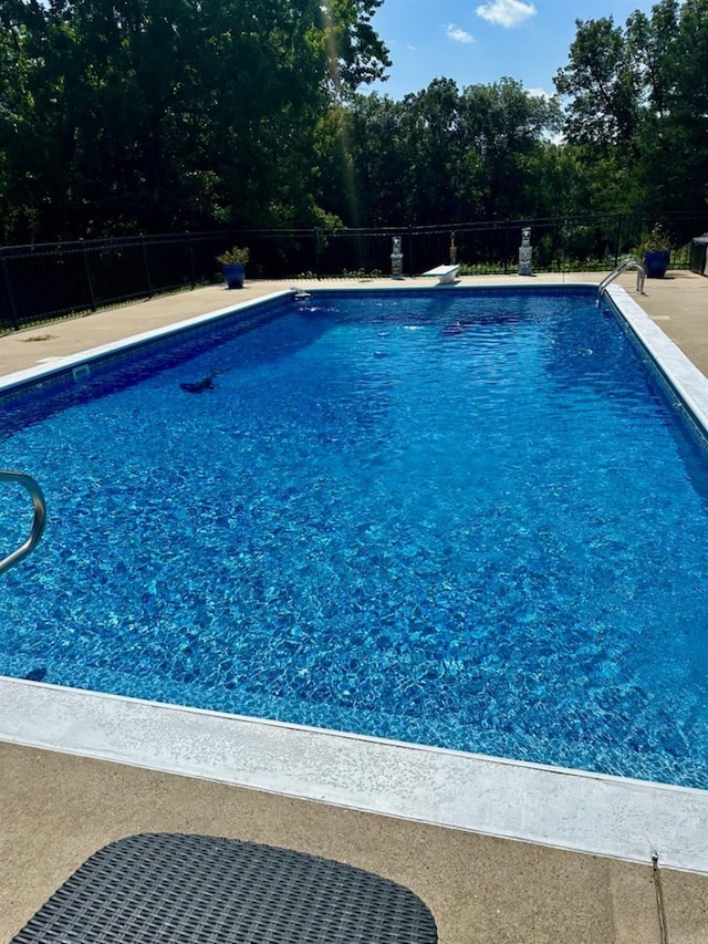 view of swimming pool with a fenced in pool and fence