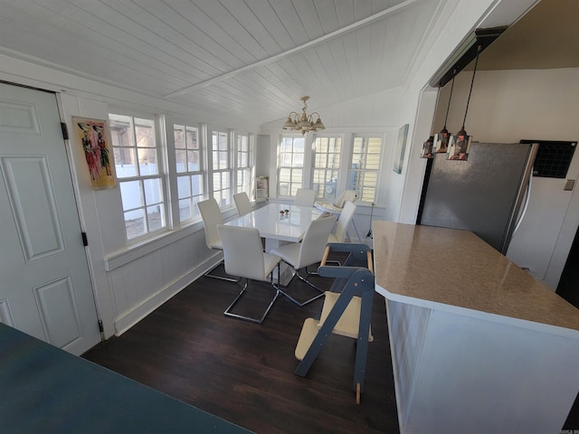 interior space with plenty of natural light, lofted ceiling, a chandelier, and dark wood-style flooring