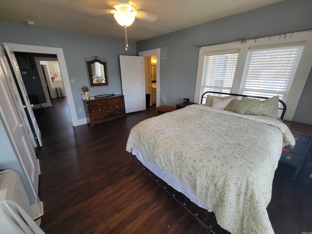 bedroom with baseboards and dark wood finished floors