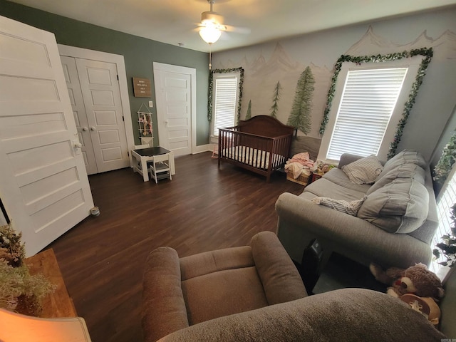 living area with a healthy amount of sunlight, ceiling fan, and wood finished floors