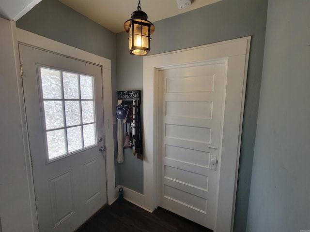 entryway featuring baseboards and dark wood finished floors