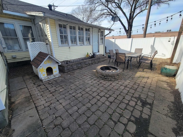 view of patio / terrace featuring a fire pit and fence