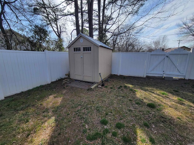 view of shed featuring a gate and a fenced backyard