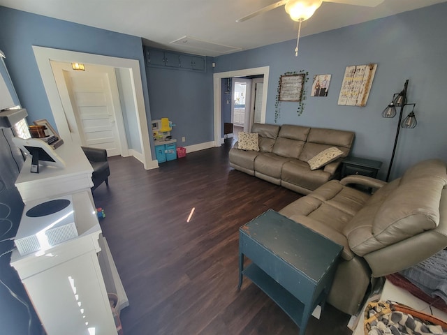 living area with dark wood-style floors, baseboards, attic access, and a ceiling fan