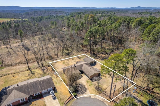 bird's eye view with a forest view and a mountain view