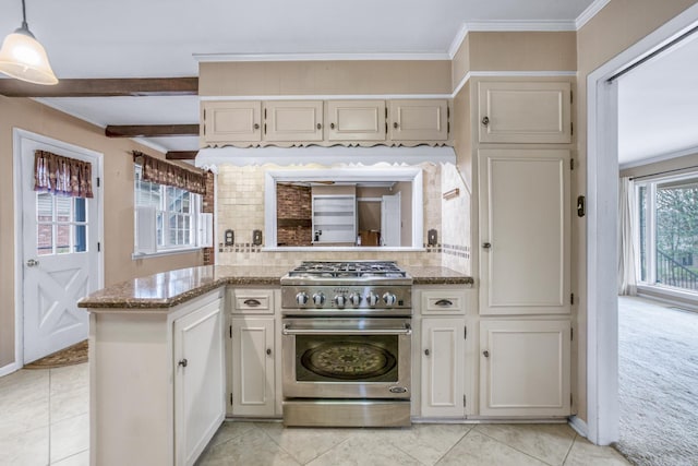 kitchen featuring high end stove, backsplash, crown molding, light stone countertops, and light colored carpet