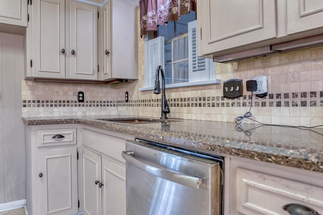 kitchen with dishwasher, decorative backsplash, stone counters, white cabinetry, and a sink