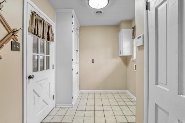 clothes washing area with laundry area, light tile patterned flooring, baseboards, and visible vents