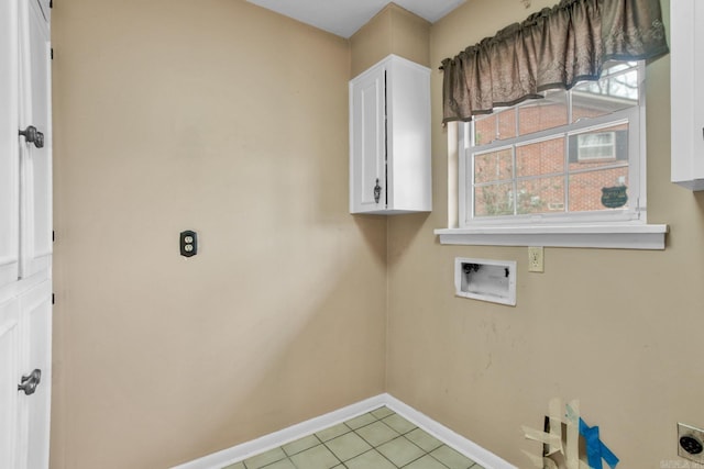 laundry room with electric dryer hookup, washer hookup, cabinet space, light tile patterned floors, and baseboards