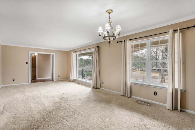 unfurnished room with a notable chandelier, ornamental molding, baseboards, and carpet floors