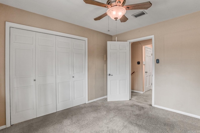 unfurnished bedroom featuring carpet flooring, baseboards, visible vents, and a closet