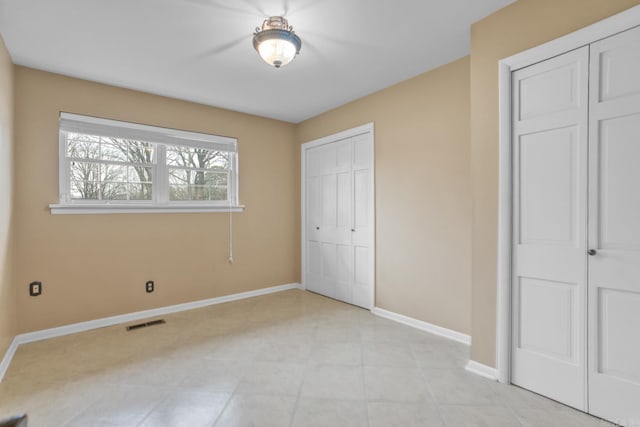 unfurnished bedroom with visible vents and baseboards