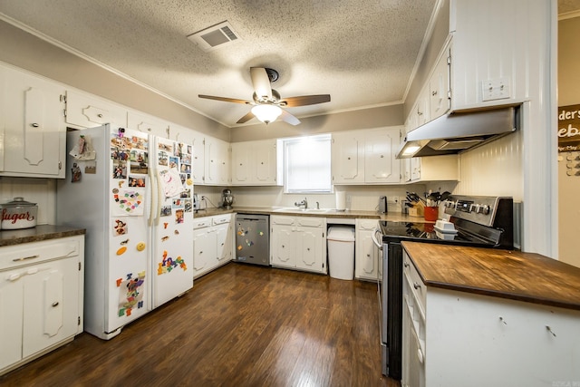 kitchen featuring visible vents, dark wood finished floors, under cabinet range hood, butcher block counters, and stainless steel appliances