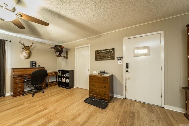 office with crown molding, a textured ceiling, and light wood-type flooring