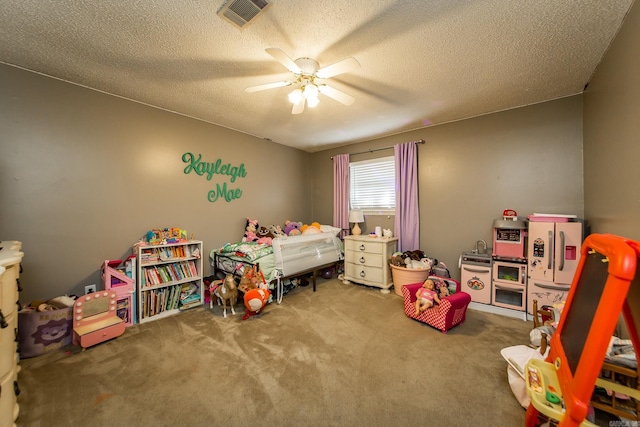 bedroom featuring visible vents, ceiling fan, a textured ceiling, and carpet