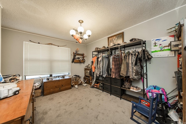 walk in closet featuring an inviting chandelier and carpet flooring