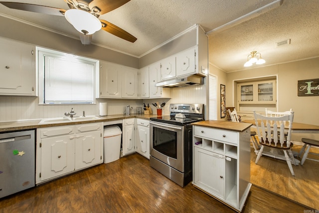 kitchen with visible vents, under cabinet range hood, ornamental molding, appliances with stainless steel finishes, and a sink