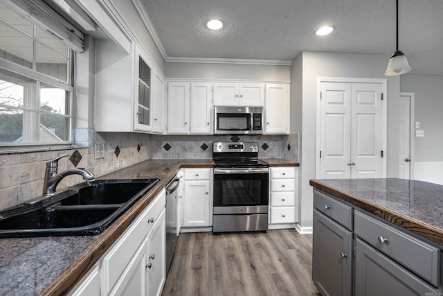 kitchen featuring a sink, gray cabinets, white cabinetry, and stainless steel appliances