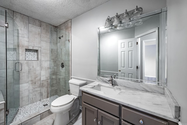 full bathroom with a shower stall, a textured ceiling, and toilet