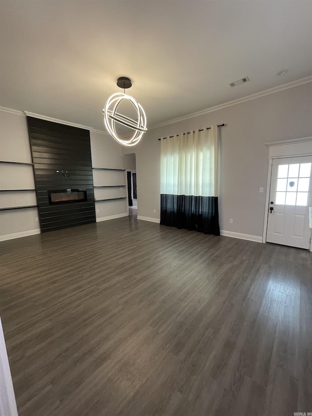 unfurnished living room featuring visible vents, a chandelier, ornamental molding, a fireplace, and dark wood-style floors