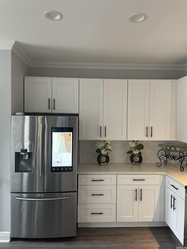 kitchen featuring ornamental molding, stainless steel fridge with ice dispenser, and white cabinetry