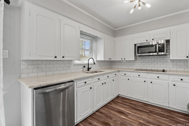 kitchen with ornamental molding, a sink, dark wood-type flooring, white cabinets, and appliances with stainless steel finishes