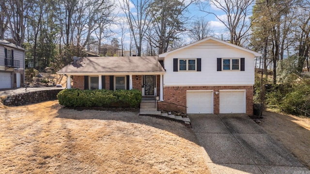 tri-level home featuring brick siding, driveway, and an attached garage