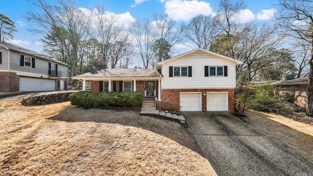 tri-level home with brick siding, concrete driveway, and an attached garage