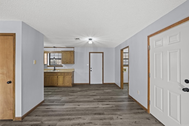 interior space with visible vents, baseboards, a textured ceiling, and dark wood-style floors