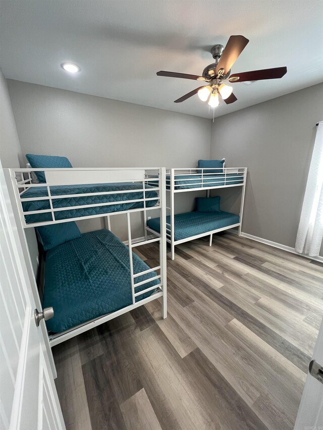 unfurnished bedroom with baseboards, ceiling fan, and wood finished floors