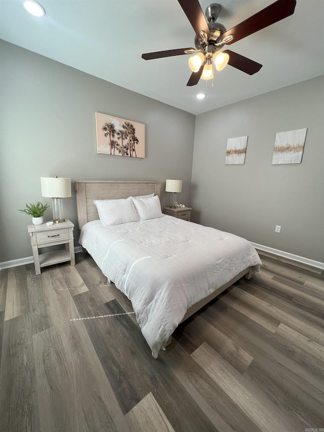 bedroom with wood finished floors, baseboards, and ceiling fan