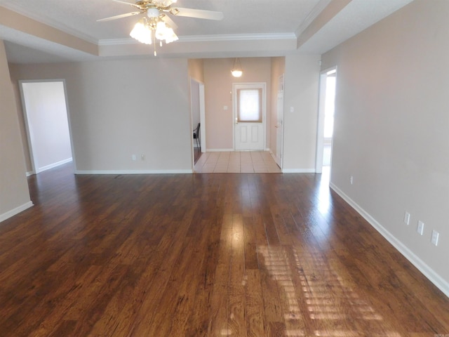 interior space featuring crown molding, baseboards, wood-type flooring, and ceiling fan