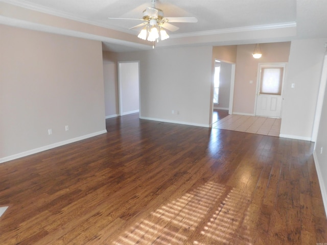 unfurnished living room with baseboards, crown molding, a ceiling fan, and hardwood / wood-style floors