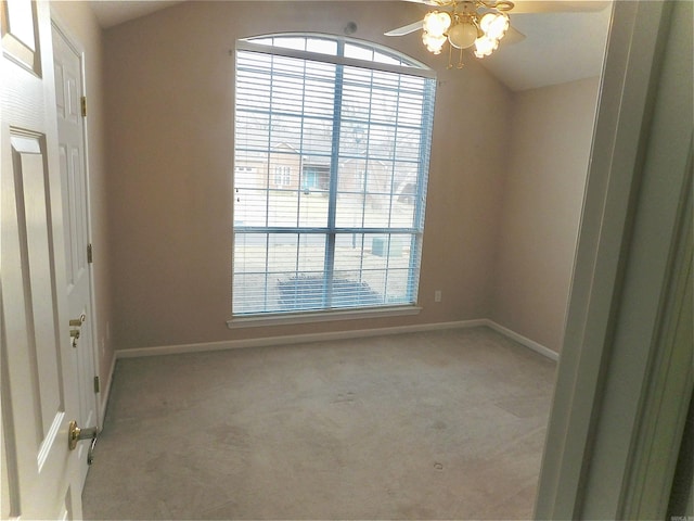 carpeted spare room with baseboards, plenty of natural light, lofted ceiling, and ceiling fan