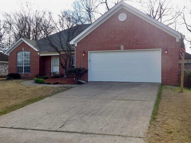 single story home featuring concrete driveway, an attached garage, and brick siding