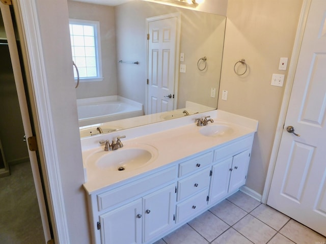 full bathroom featuring a sink, a bath, double vanity, and tile patterned flooring