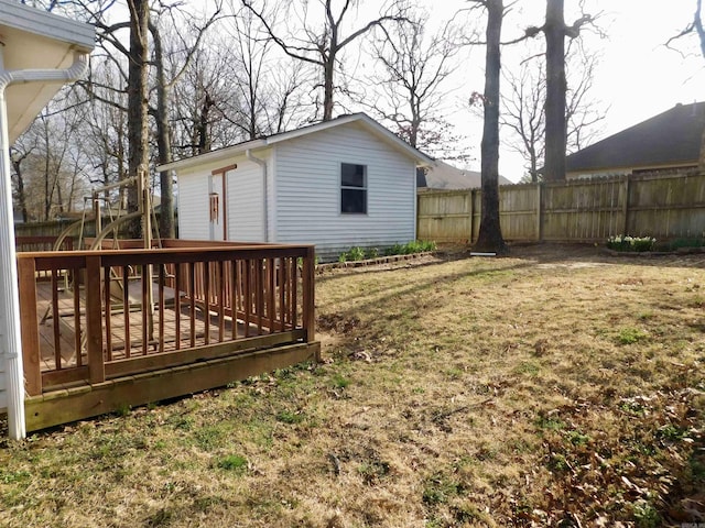 view of yard with a deck and fence