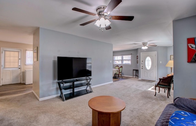 living area with baseboards and carpet