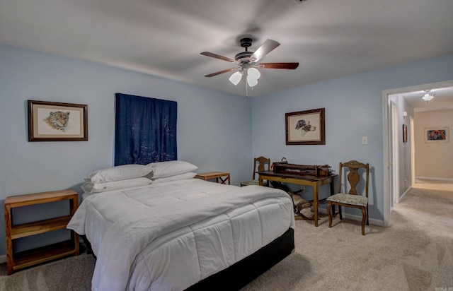 bedroom with a ceiling fan, light colored carpet, and baseboards