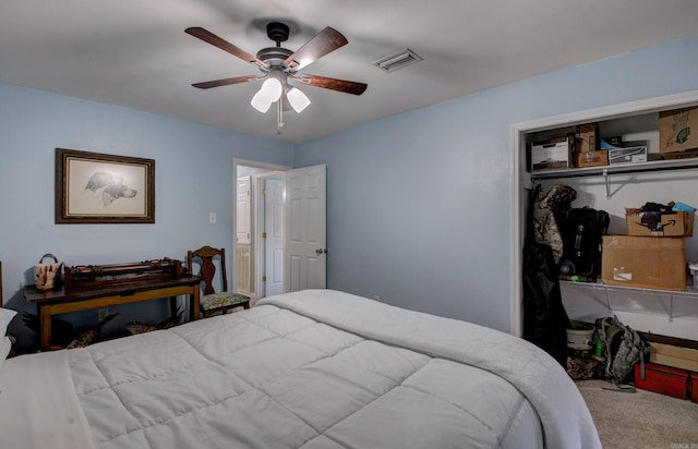 carpeted bedroom featuring a ceiling fan, visible vents, and a closet