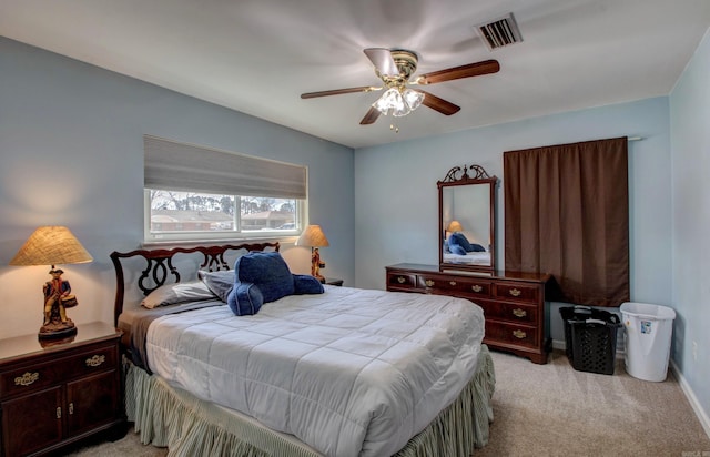 bedroom with a ceiling fan, light colored carpet, visible vents, and baseboards