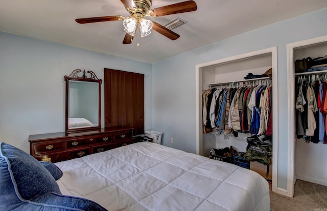 carpeted bedroom featuring a ceiling fan, baseboards, and visible vents