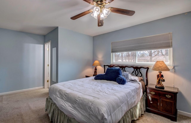 carpeted bedroom featuring baseboards and ceiling fan